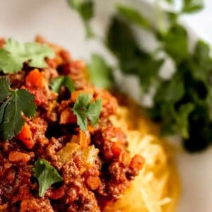 A bowl of spaghetti squash with whole30 spaghetti meat sauce.